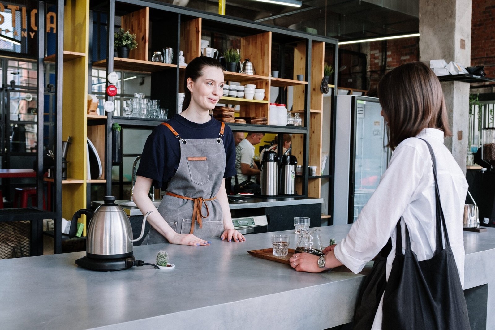 barista in a coffeeshop serving a customer